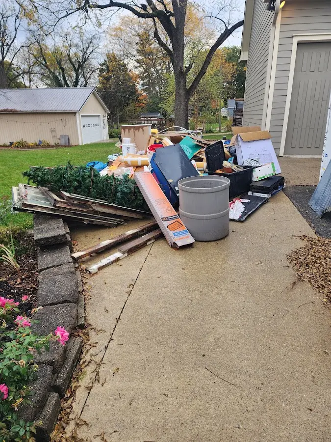 Dumpster being loaded with debris for Estate Cleanout Dumpster Rental in Clay
